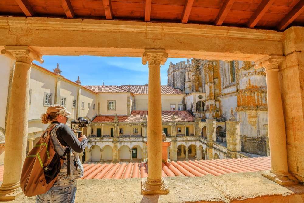 Traveler taking pictures in the Monastery of Tomar, Portugal